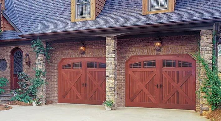 A mahogany carriage house garage door with wrought hardware