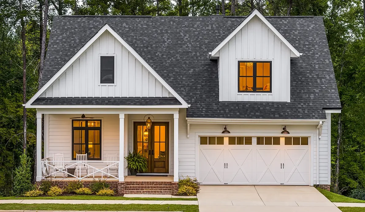 Two mint green carriage house doors on a traditional home