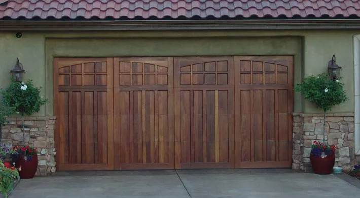 Three arched carriage doors on a stone faced home