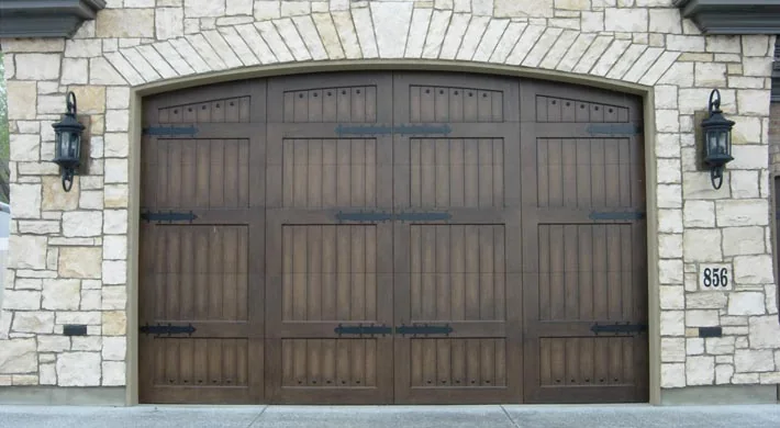 Two timber carriage house doors under a heavy timber header