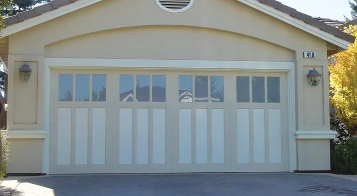 Two walnut carriage house garage doors with window rows