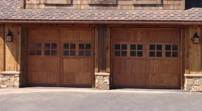 Three white carriage house garage doors with arched glazing