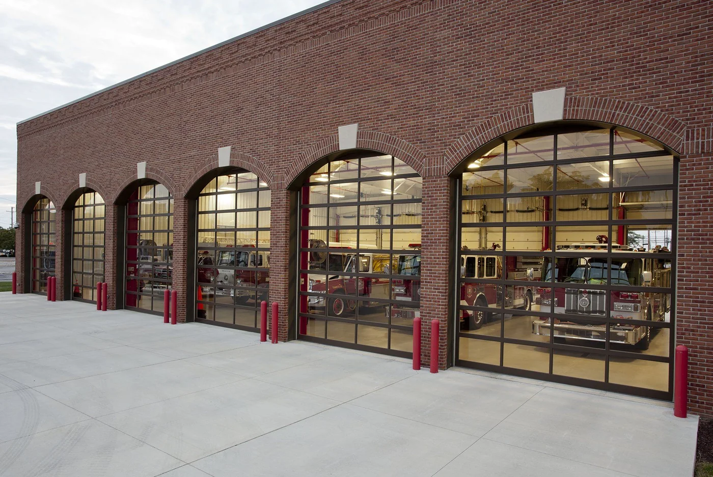 Arched glass bay doors on a brick municipal building