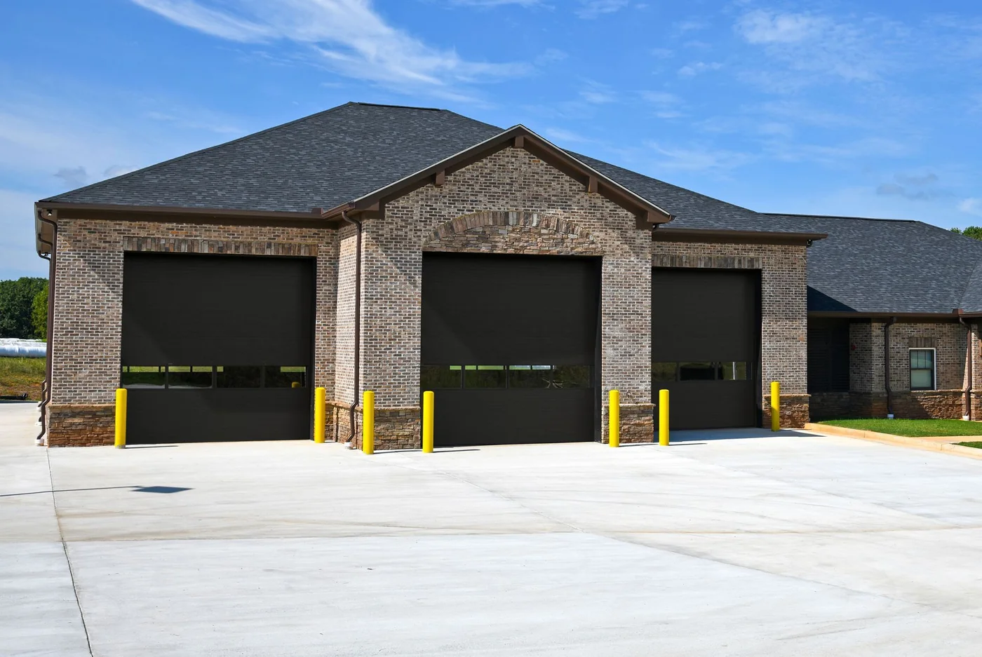 A brick service building with a row of sectional doors