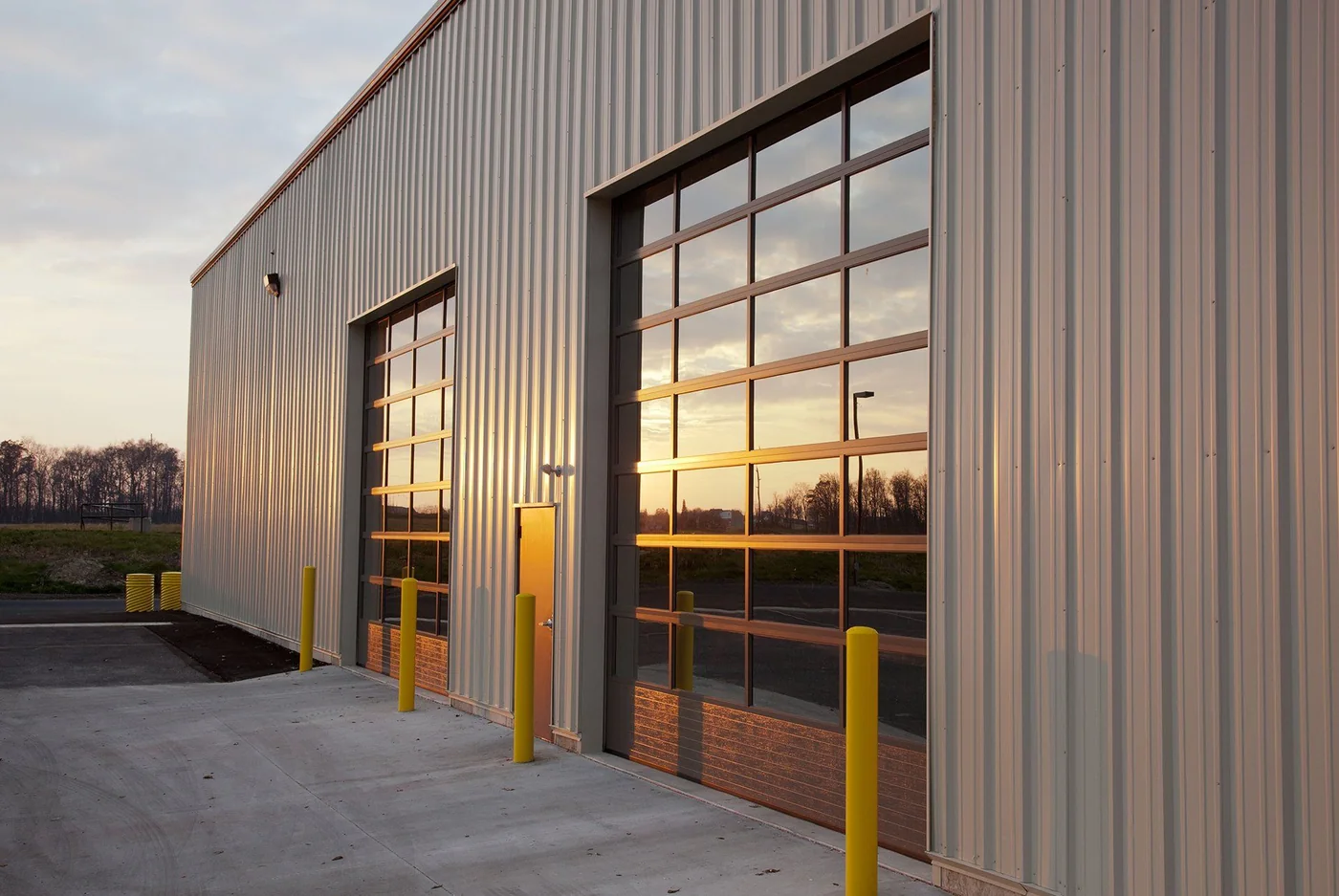 A commercial glass door catching low sunset light