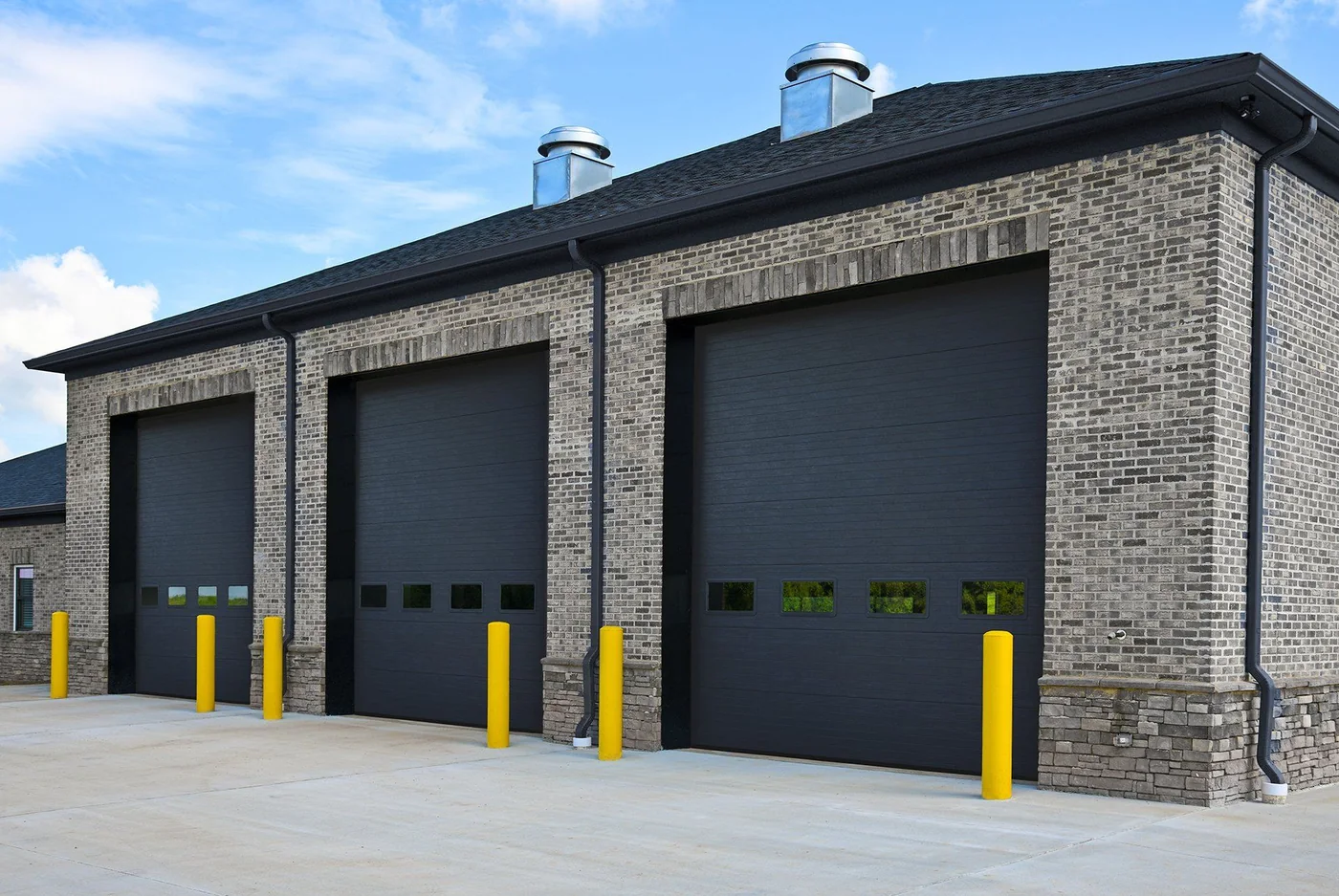 Three commercial doors with protective bollards