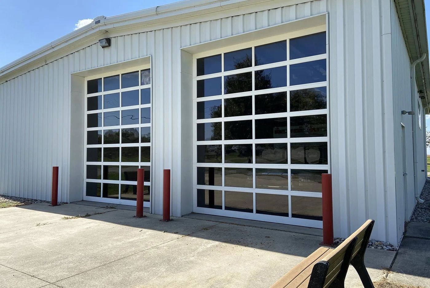 A tall white commercial door on a service building