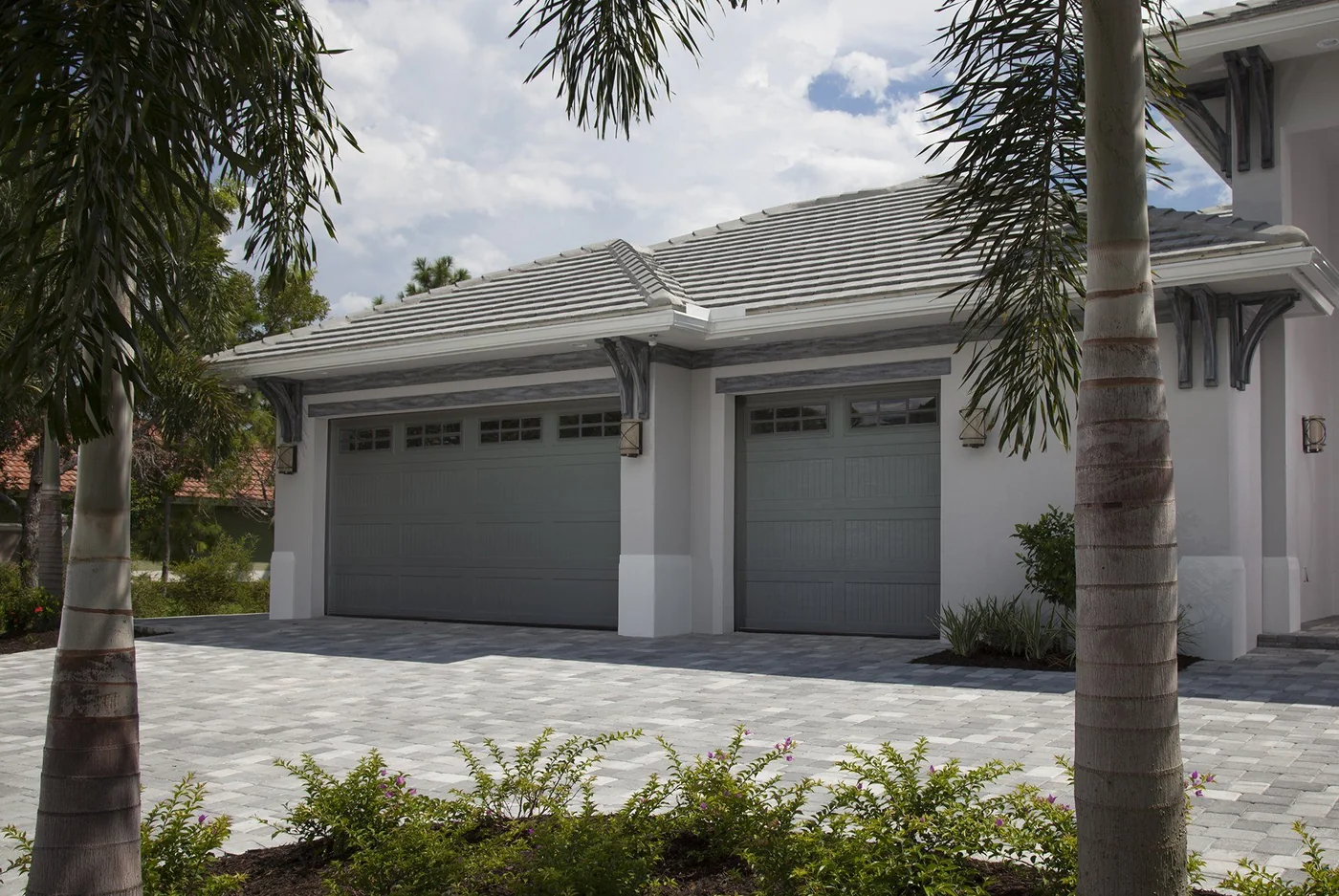 A three bay garage under palms on a South Florida home