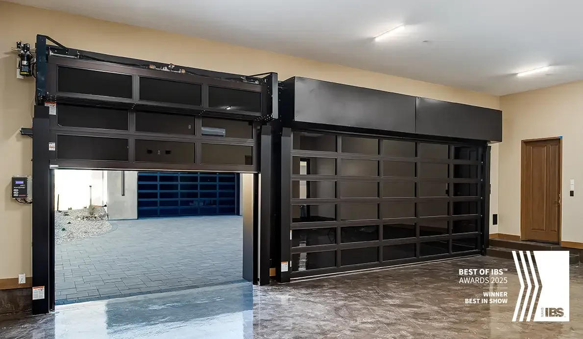 Full view aluminium and glass garage doors lit from inside at night