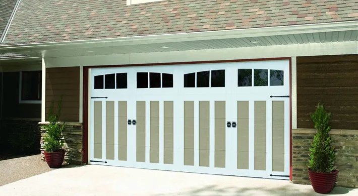 A wood grain modern garage door on a house lit at dusk