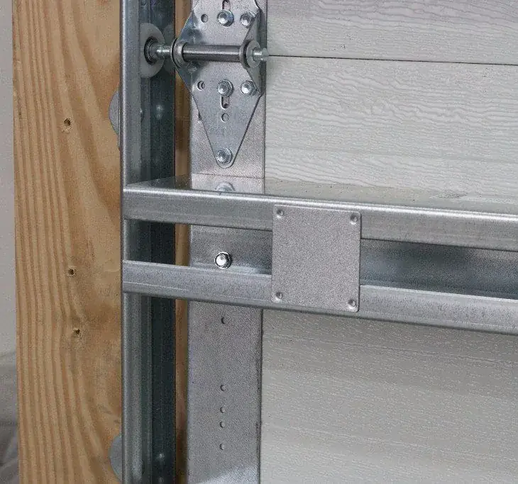 A close view of a garage door track and rail assembly