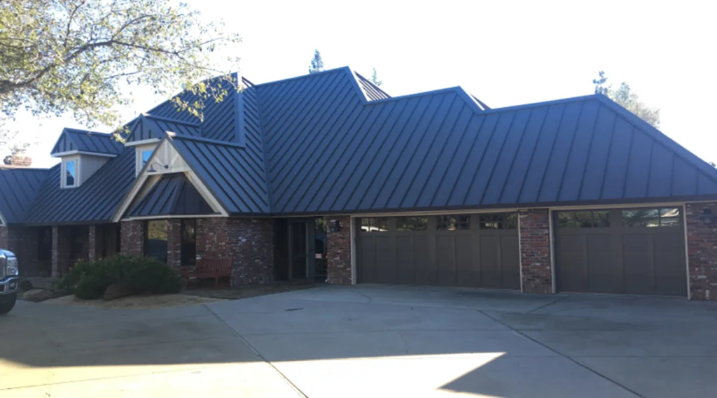 A low ranch home with three garage doors under a wide roof