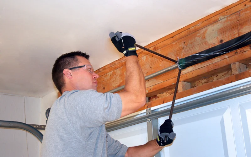 Technician fixing the opener rail back to the timber framing above the door