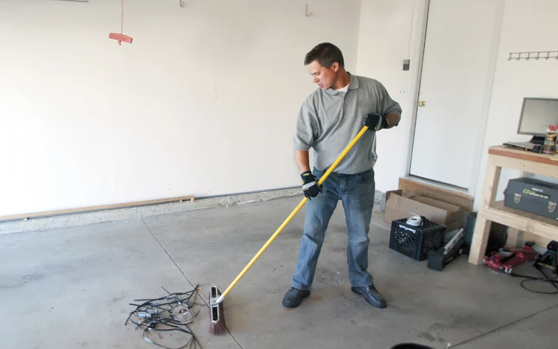 Technician measuring a garage opening before fitting a door