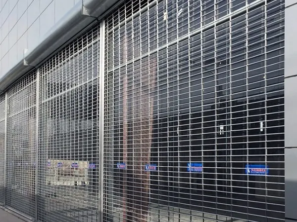 A long stainless rolling grille closed across a building frontage