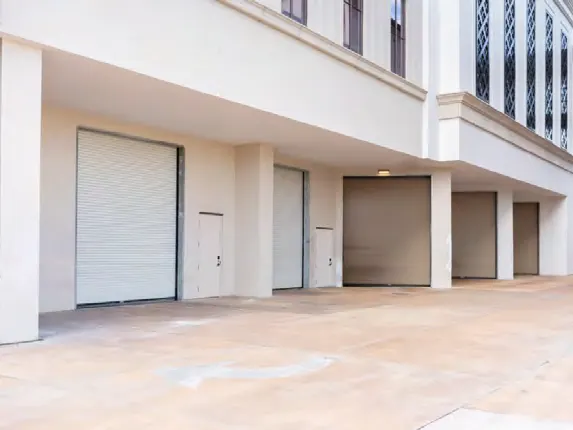 Rolling service doors along the ground floor of a mixed use building