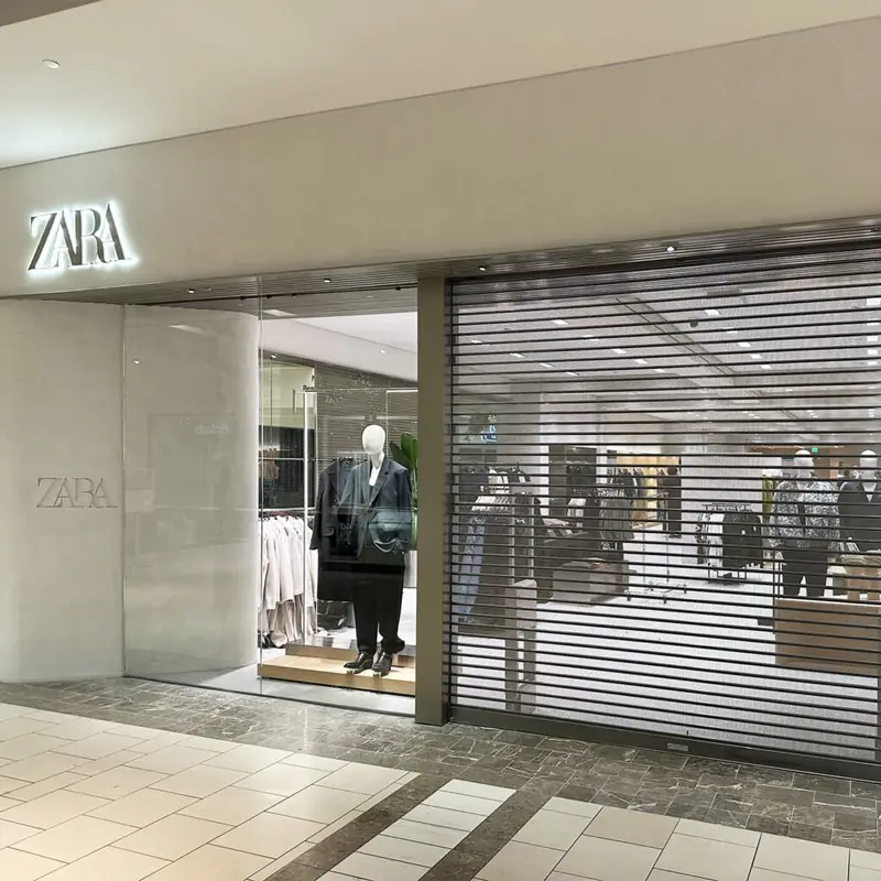 Perforated rolling curtain on a retail storefront