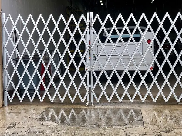 A side folding security gate drawn across a storefront opening