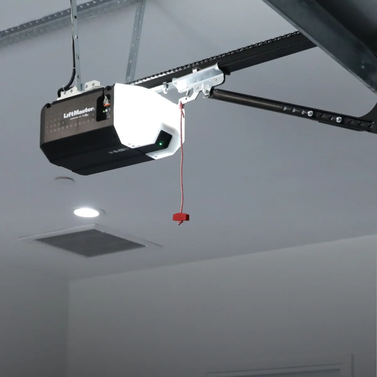 LiftMaster 2420L chain drive opener installed on a garage ceiling with the emergency release cord