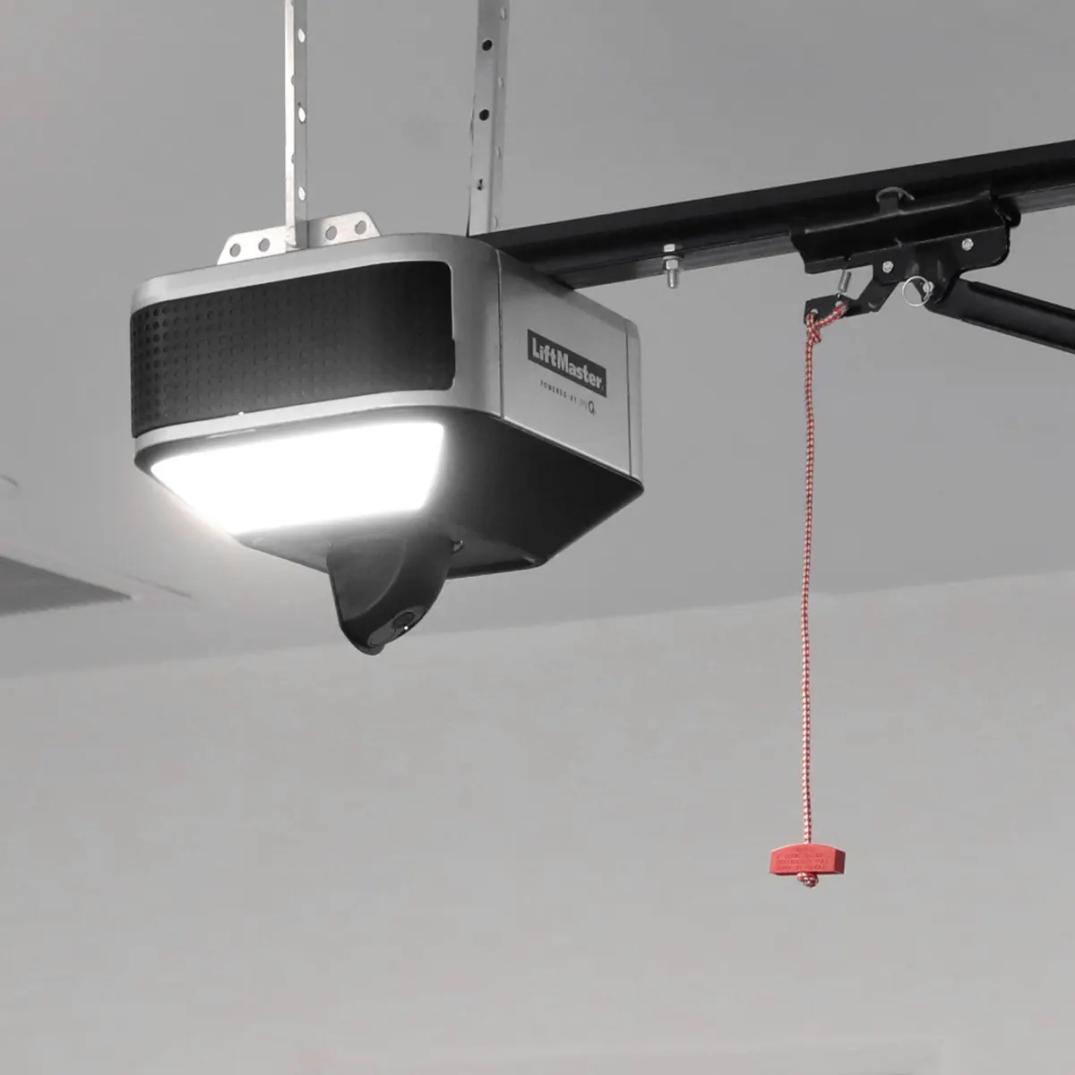 LiftMaster 6580L belt drive opener installed on a garage ceiling with its light on