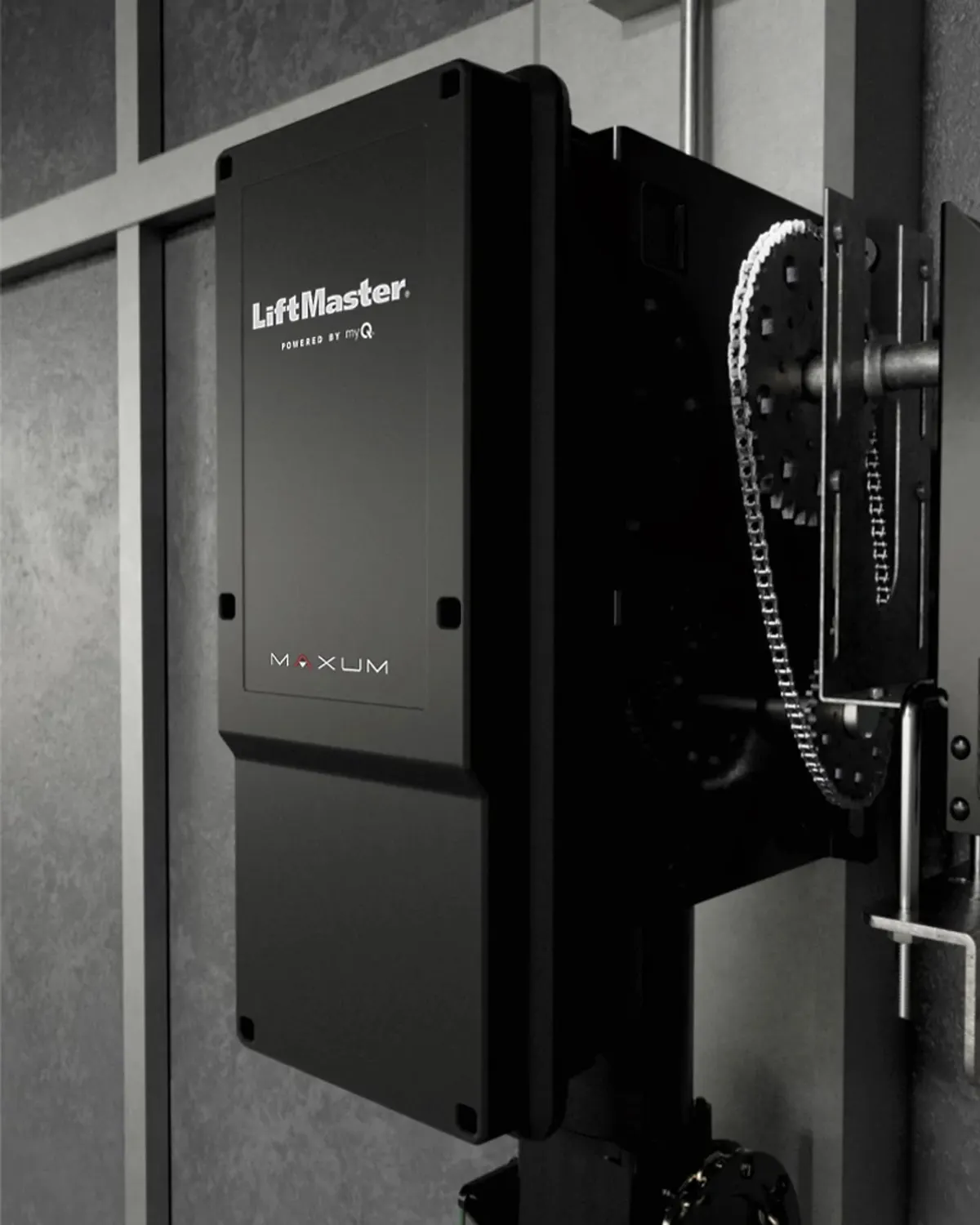 LiftMaster Maxum JHDC hoist operator installed on a commercial building wall with its chain hoist